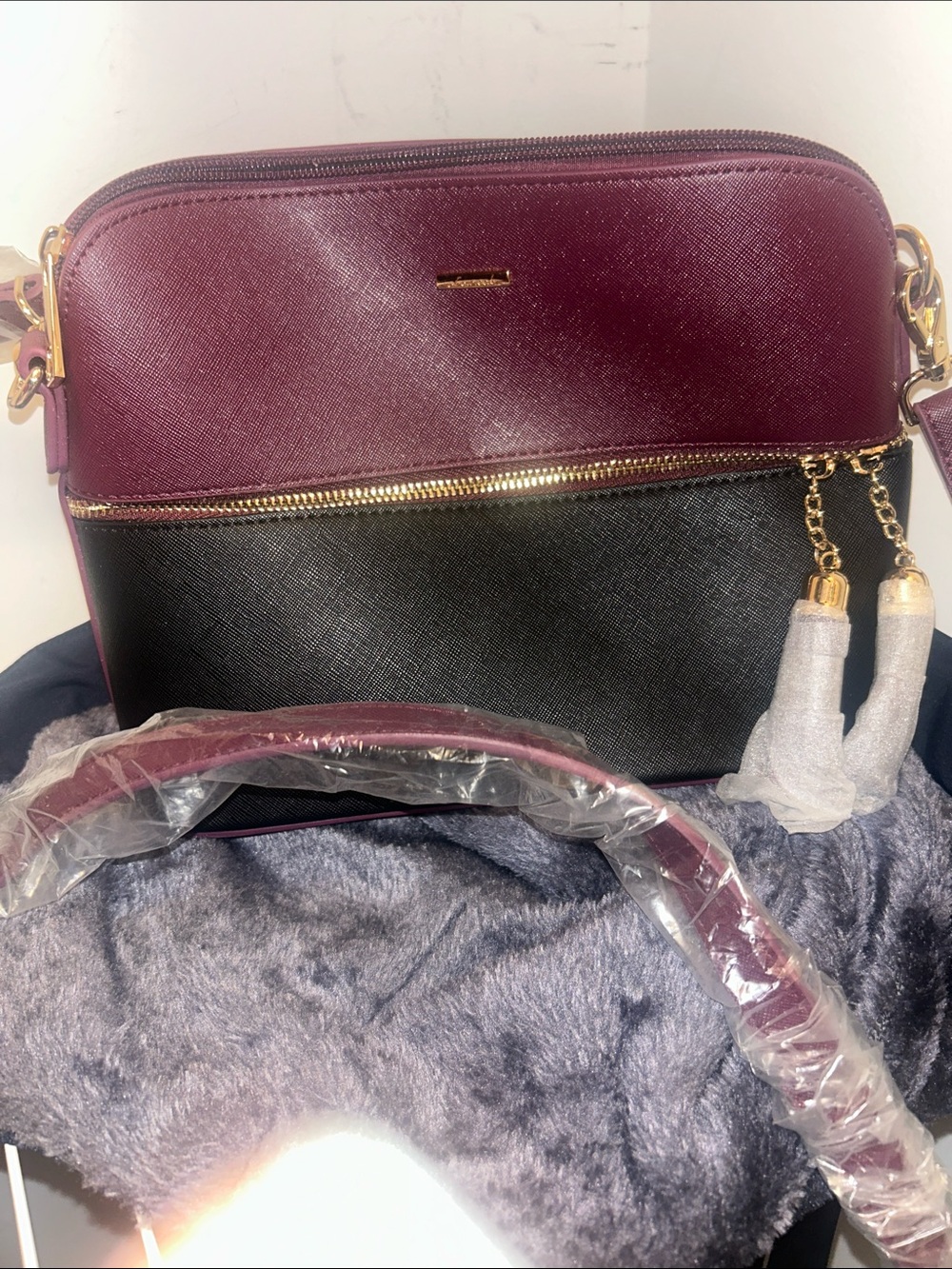 Two-Tone Plum and Black Crossbody with Gold Tassel Detail